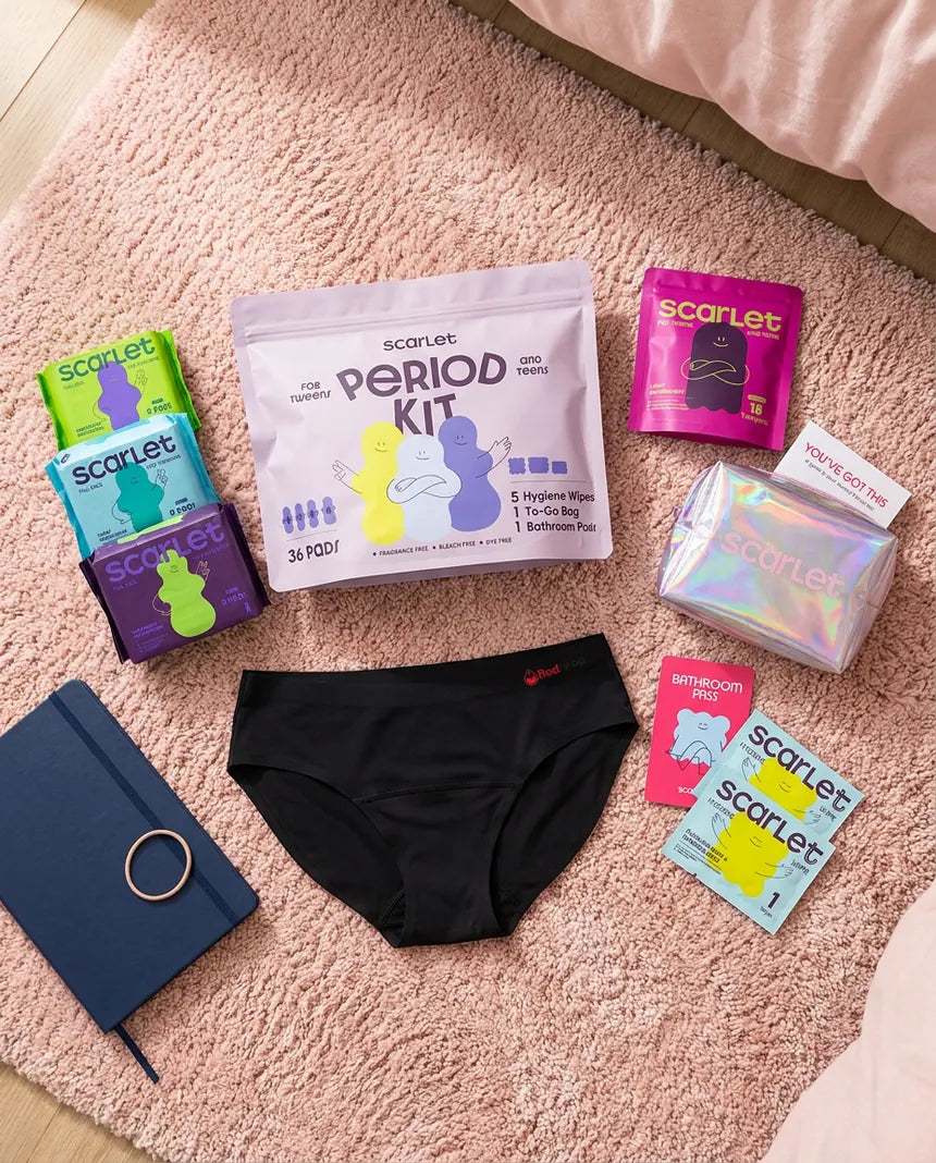 Scarlet Signature Kit contents laid out on a bedroom rug